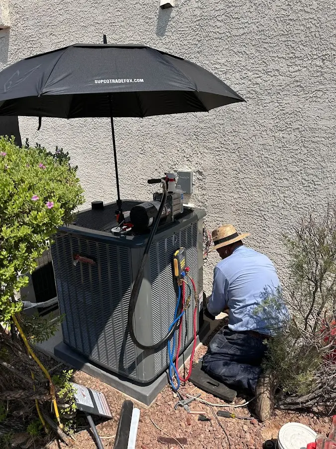 HVAC technician performing outdoor AC maintenance in Vincent